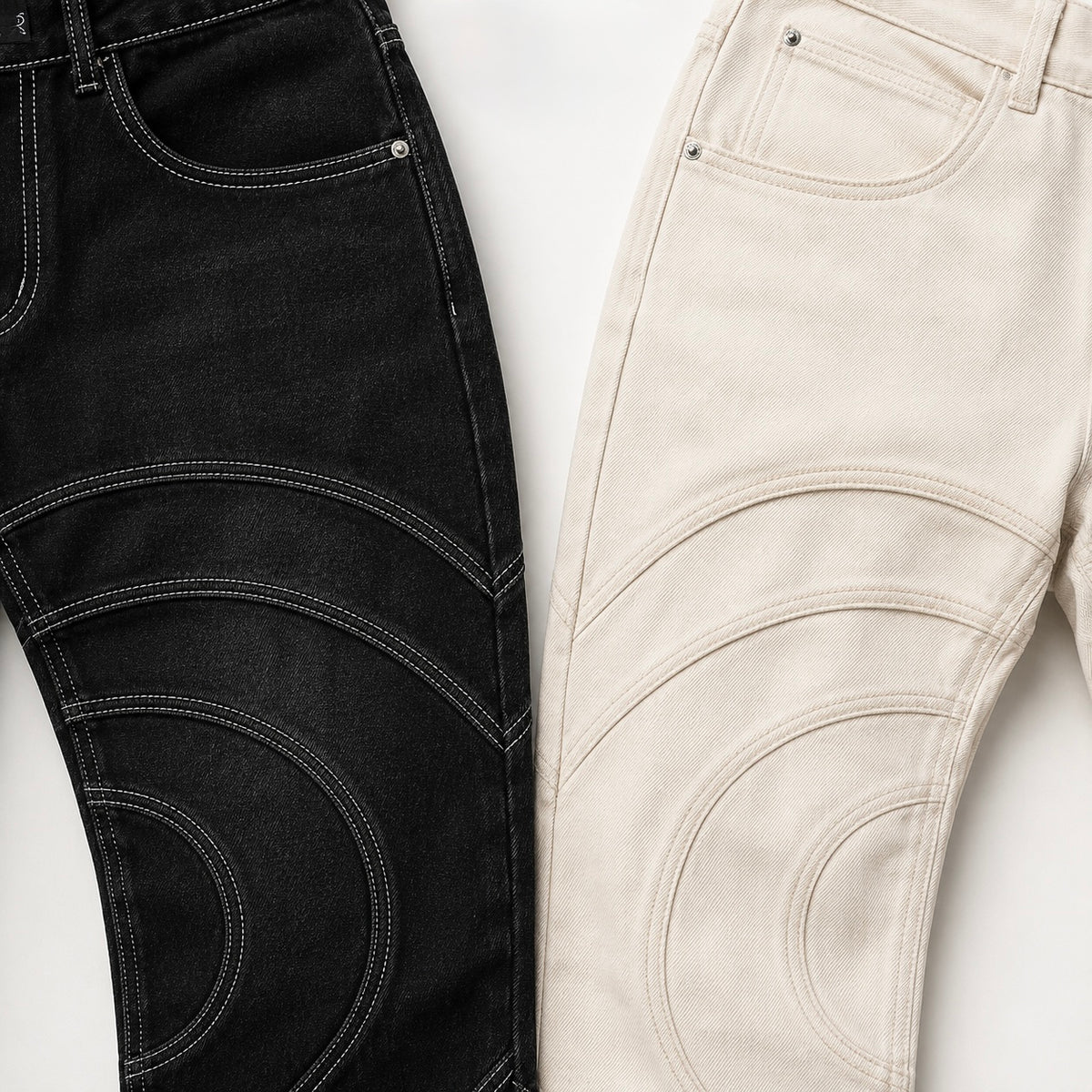 Close-up of the Voyager denim pants construction and contrast topstitching in Midnight and Limestone, both showing curved seam detailing and pocket construction.