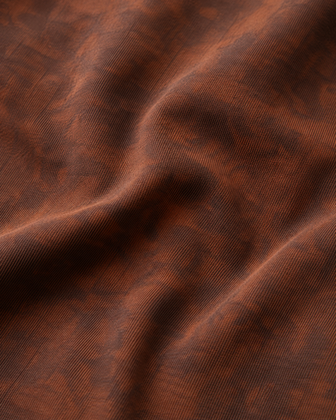 A close-up of heavyweight draped sunfaded brown fabric with a subtle woven texture and soft folds.