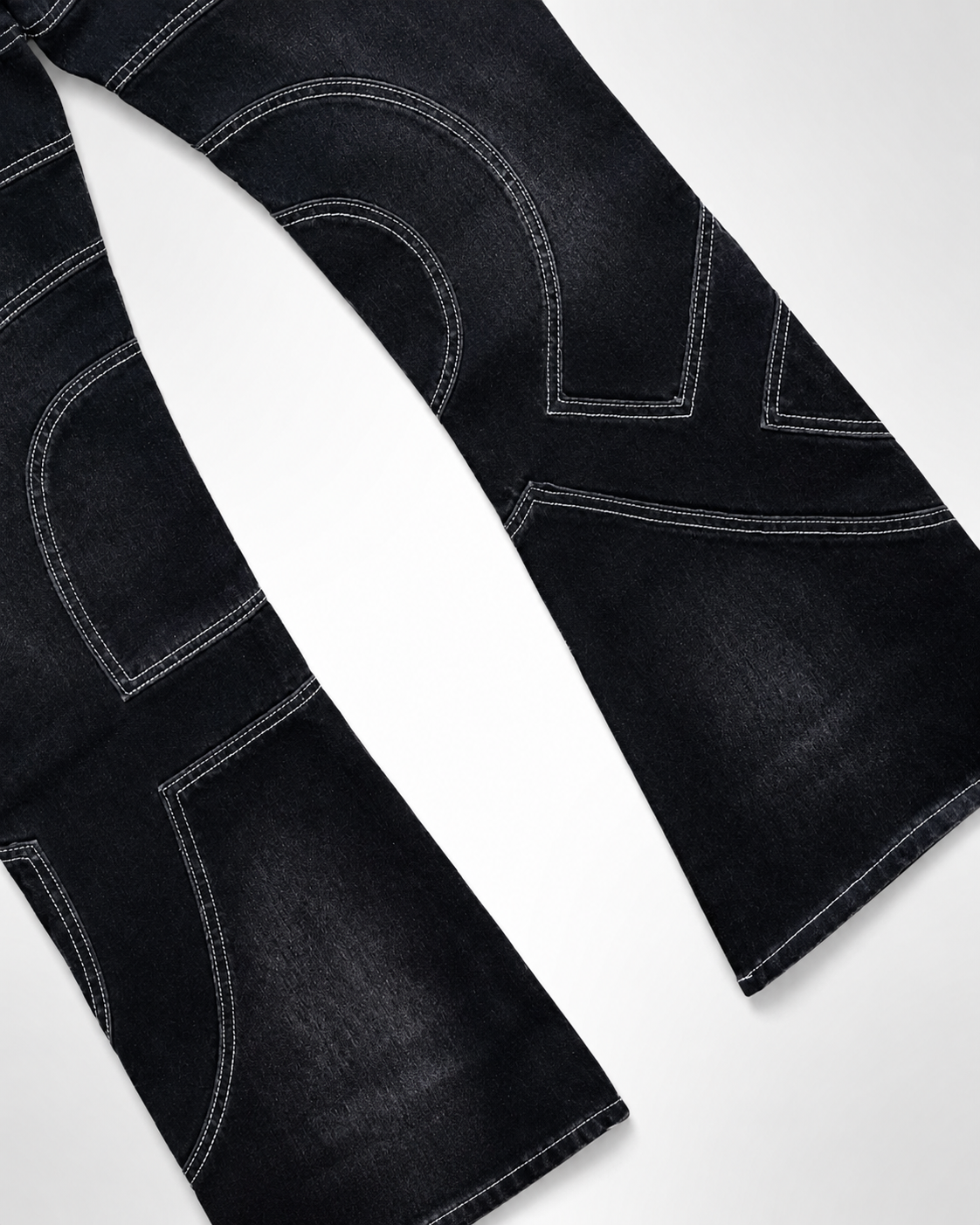 Close up of curved light grey double-needle topstitching on the Midnight Voyager Denim pants.