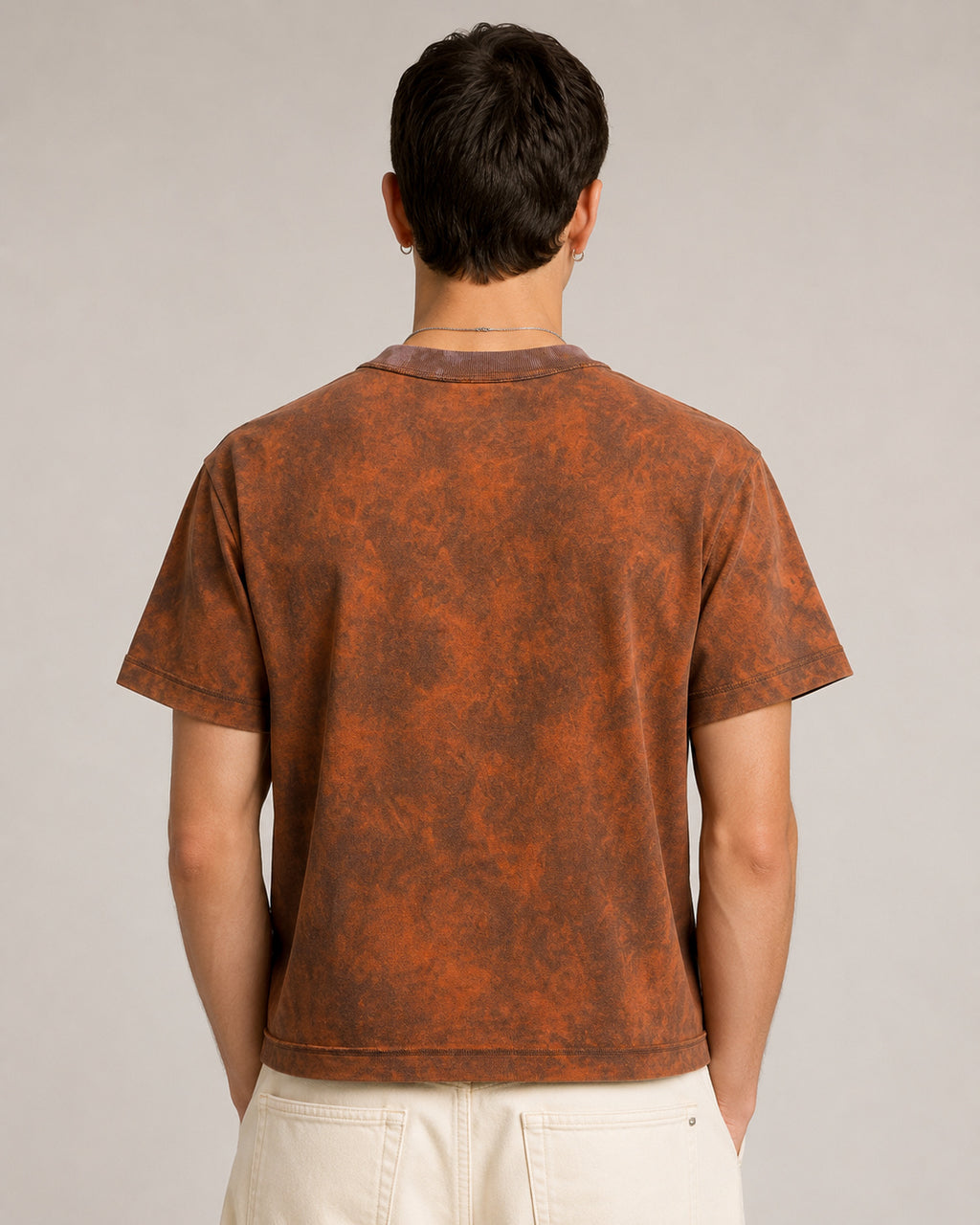 model wearing Sunfaded Reversible T-Shirt worn inside out, back view, showing exposed overlock seams showing the relaxed shoulder and cropped silhouette.