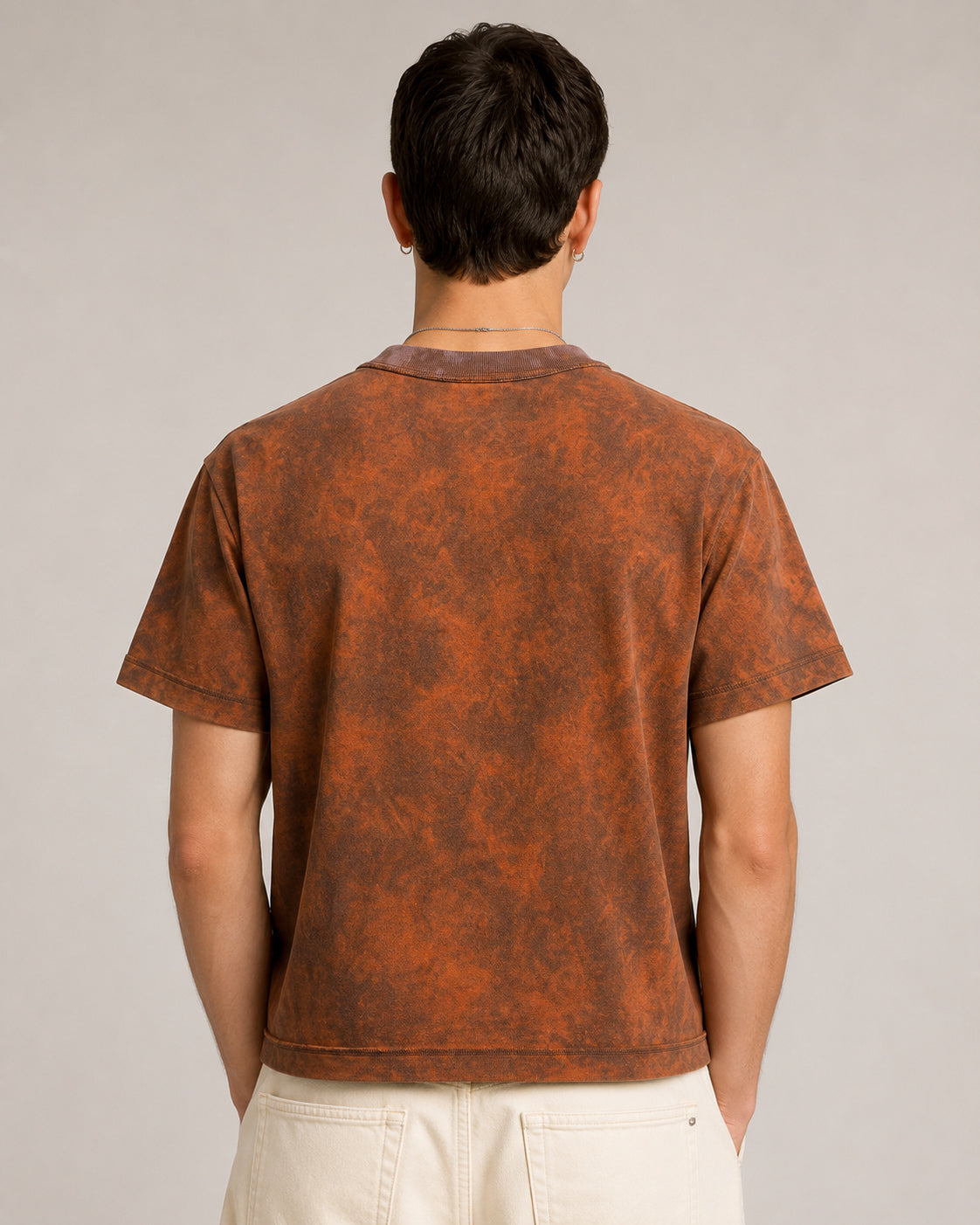 model wearing Sunfaded Reversible T-Shirt worn inside out, back view, showing exposed overlock seams showing the relaxed shoulder and cropped silhouette.