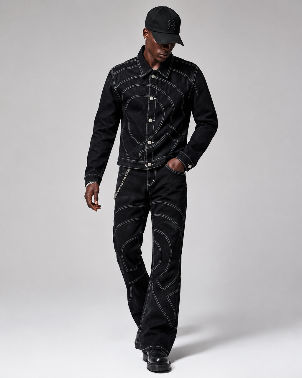 Model wearing the Midnight Voyager Denim Jacket and matching denim pant in a complete Voyager look. paired with a black baseball cap.