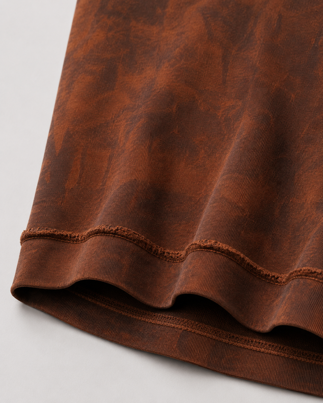 Close-up of the exposed overlock seam construction on the reversible Sunfaded T-Shirt.