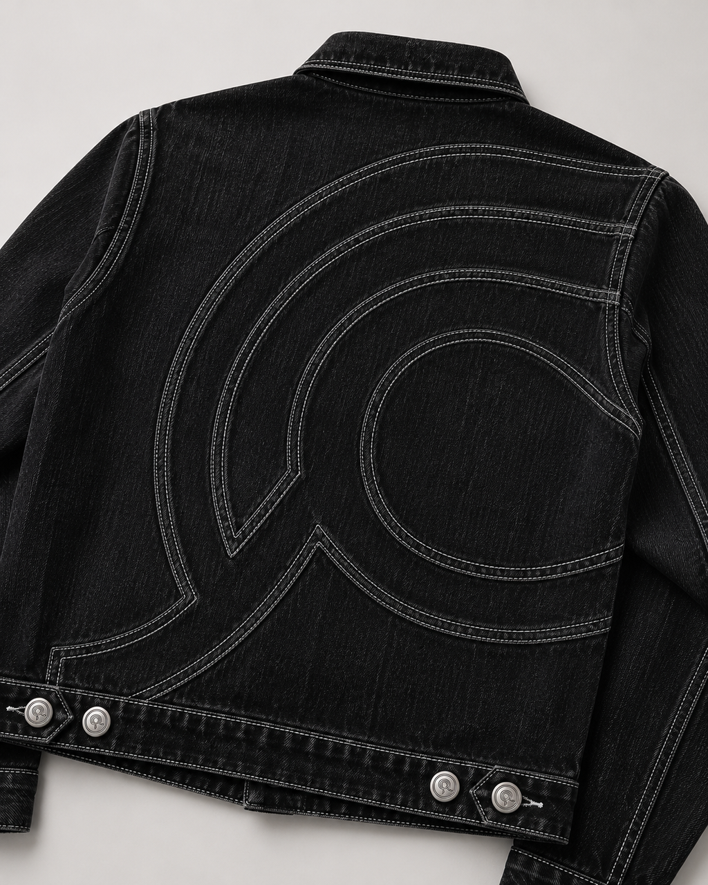 Close up of curved light grey double-needle topstitching on the Midnight Voyager Denim Jacket.