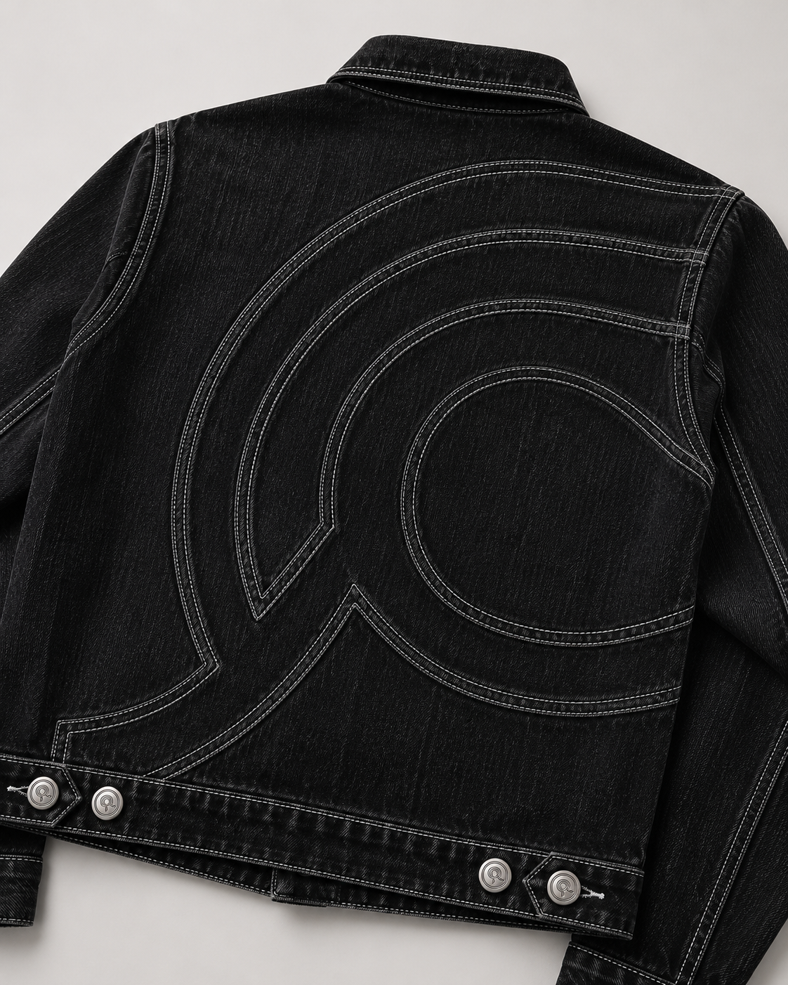 Close up of curved light grey double-needle topstitching on the Midnight Voyager Denim Jacket.