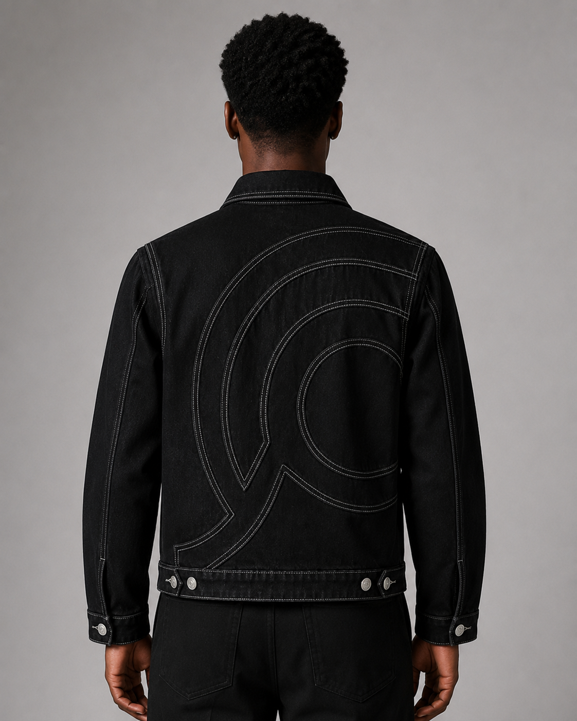 Model wearing the Midnight Voyager Denim Jacket, back view, showing the structured fit and contrast seam detailing.
