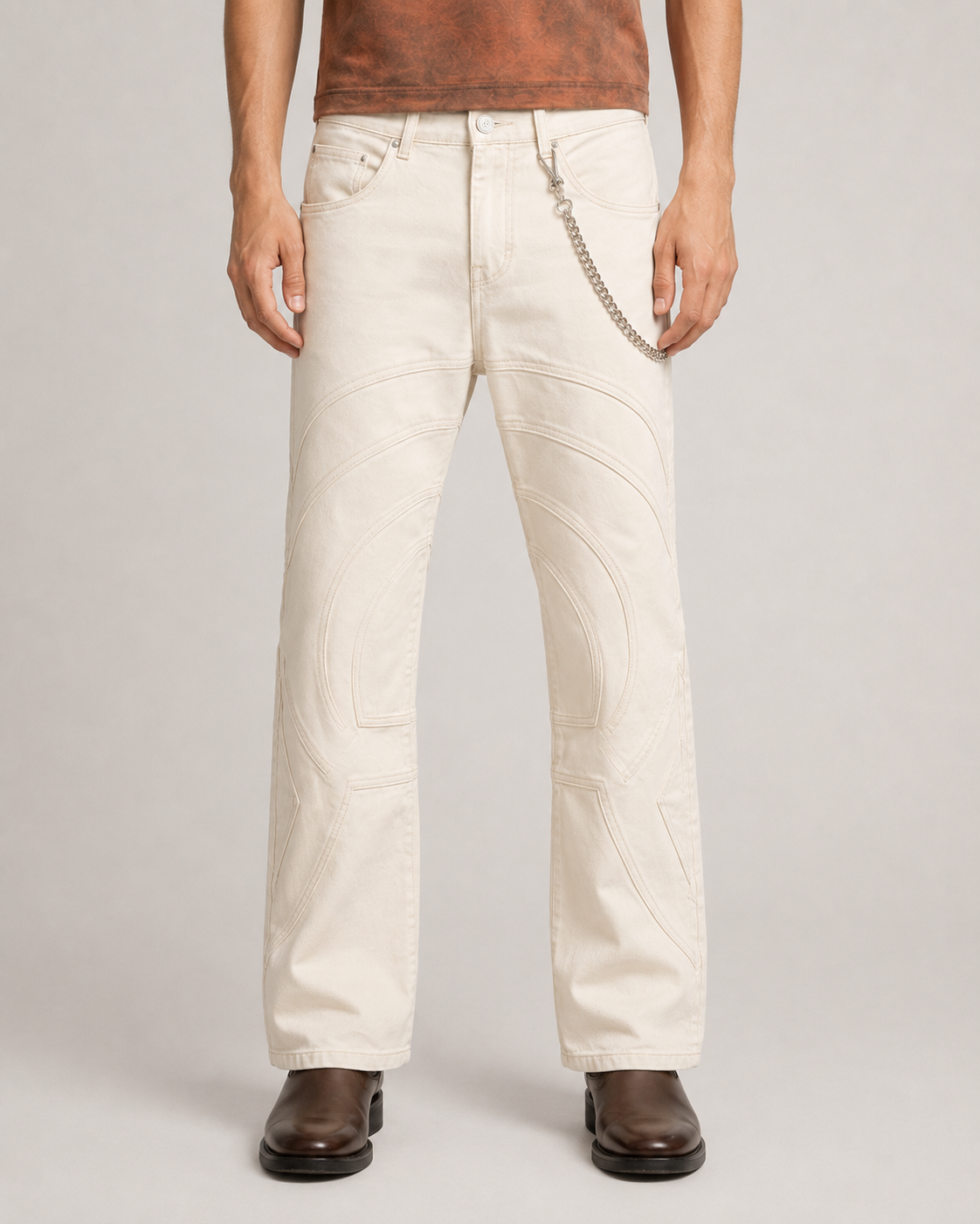 Model wearing the Limestone Voyager Denim Pant, front view, showing its slim fit and controlled flared silhouette.