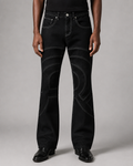 Model wearing the Midnight Voyager Denim Pant, front view, with curved light grey contrast topstitching.
