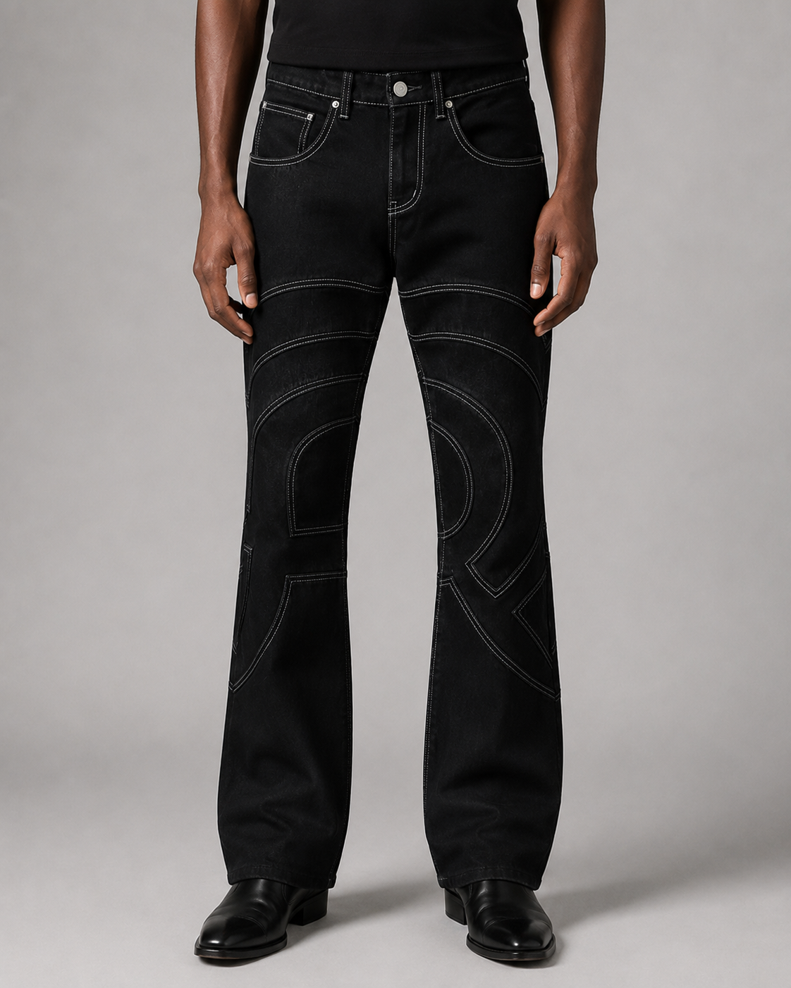 Model wearing the Midnight Voyager Denim Pant, front view, with curved light grey contrast topstitching.